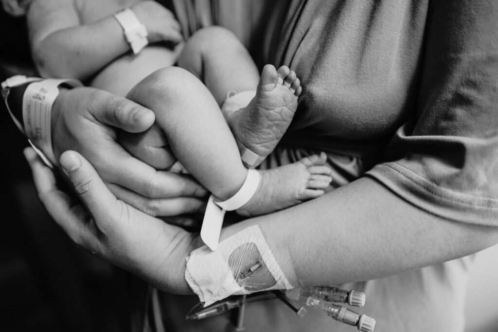 close up photo of newborn and mothers arms 
fresh 48 photography