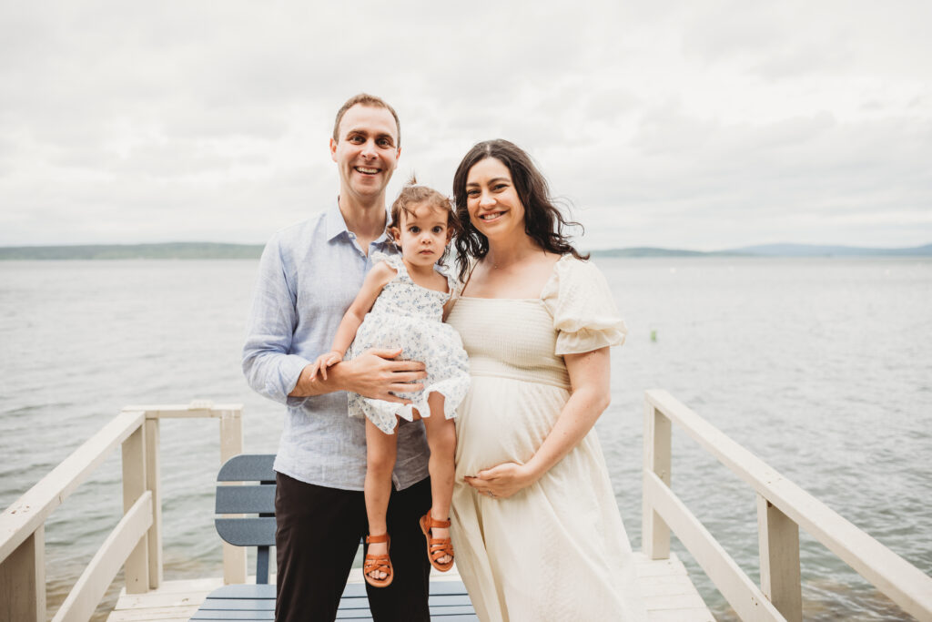 Expecting family photographed by Blue Hill maternity photographer on private dock